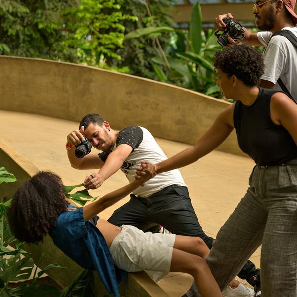 Diverse group of people smiling during a light yoga session.
