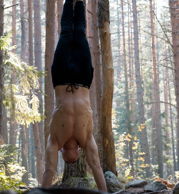 Person feeling energized and stretching in a natural outdoor setting.